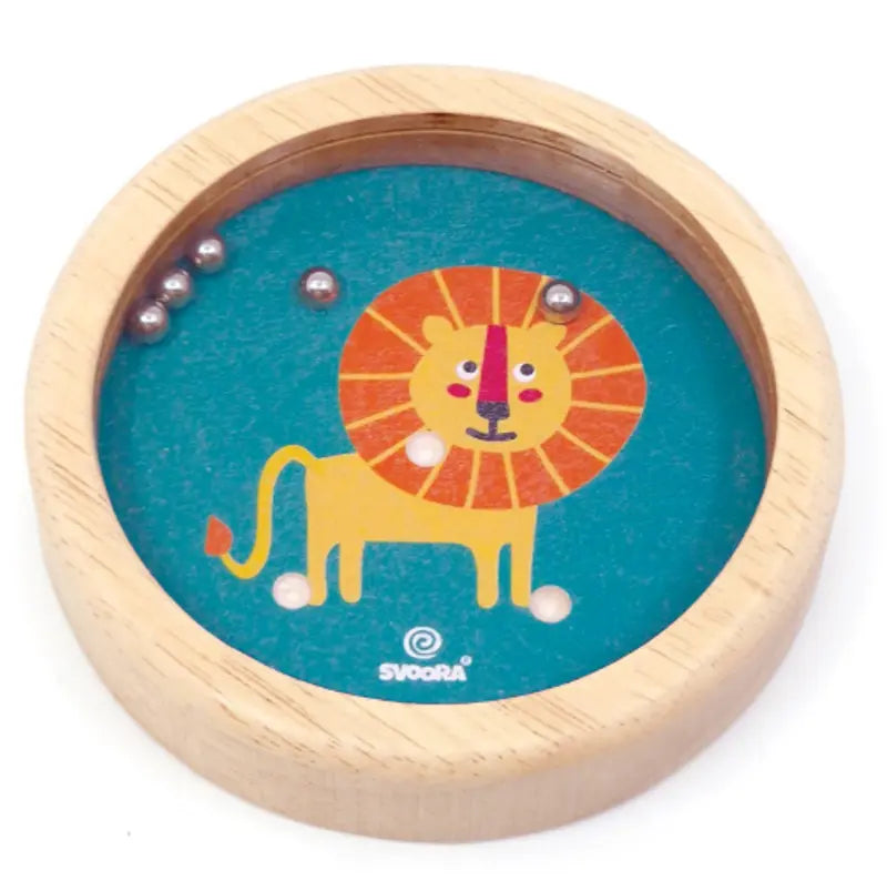 The Wooden Balance Game Lion features a playful illustrated lion on teal wood. Kids guide small metal balls into holes, making it a fun and portable balance toy perfect for travel.