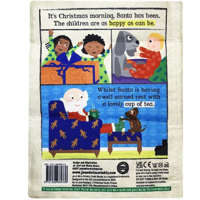 An illustrated children's book page features joyful kids and a dog on Christmas morning as Santa relaxes with tea, gifts, and the "Crinkly Cloth Book A Busy Night For Santa"—a perfect Christmas baby gift.