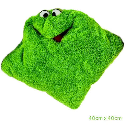 The Cuddle Hand Puppet Pillow in Green features a playful monster face with big white eyes and a red mouth. Measuring 40cm by 40cm, this square, fuzzy pillow doubles as a sensory toy for endless fun.