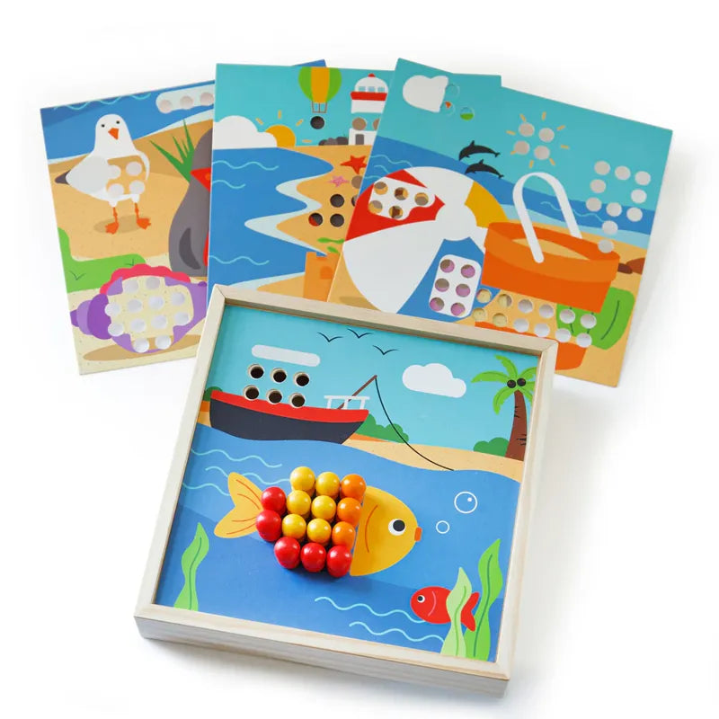 The Bigjigs Seaside Peg Board is a children's color matching game with a wooden fish peg board to develop fine motor skills. It includes three extra beach-themed puzzle boards showing scenes with a seagull, sandcastle, and picnic basket to engage young minds.