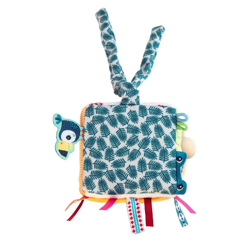 The "Lilliputiens I'm Discovering Jack Activity Cube" is a soft square fabric block with crinkly textures, a green leaf pattern, colorful loops, and a cartoon bird head. It features two long twisted handles on top for easy gripping, ideal for multiple developmental stages.