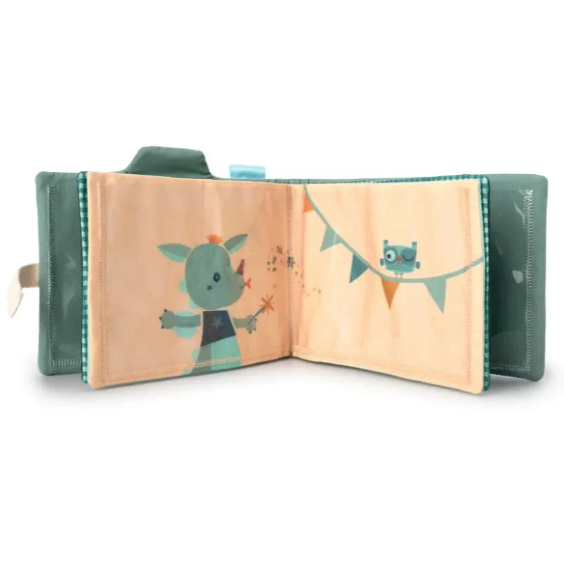 The Lilliputiens I'm Discovering Joe Photo Album is a soft, fabric baby book with a green cover featuring decorative stitching. It unfolds to reveal a teal cartoon animal and bunting, making it an ideal present for parents and perfect for capturing memories during car journeys.