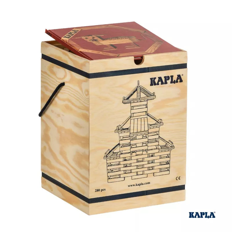 The KAPLA® Construction 280 Planks in Wooden Box features an illustration of a creatively crafted structure. The box is designed with a red and yellow lid, black straps, and the iconic KAPLA logo printed in blue.