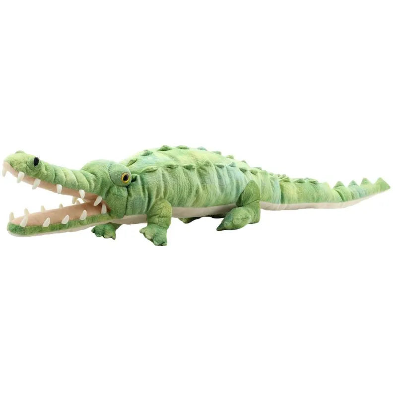 The Puppet Company Large Creature Crocodile features a plush green design, detailed scales, and yellow eyes. Its long pointed snout and open mouth with white teeth make it perfect for imaginative play as it lies flat on its stomach with short legs.