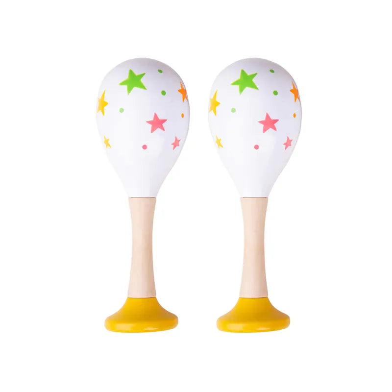 The Bigjigs Junior Maracas Yellow are two white maracas with colorful stars and dots, featuring wooden handles and bright yellow bases, ideal as musical toys to inspire toddlers' rhythmic creativity.