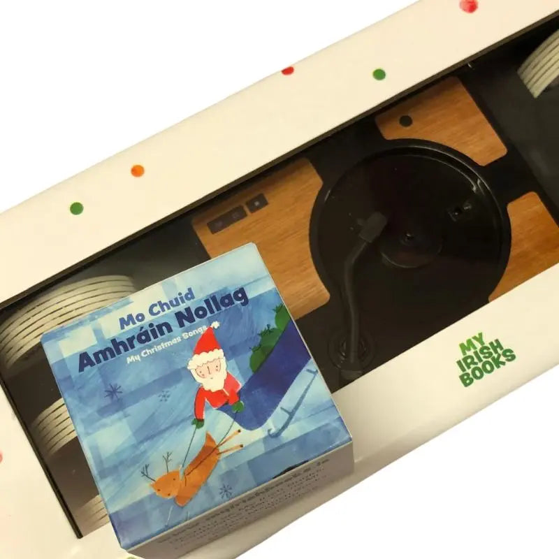 A festive "Mini Discs 16 Christmas Songs" box sits atop a Mini Gramophone in white packaging from "My Irish Books"—perfect for enjoying classic Christmas songs in Irish.