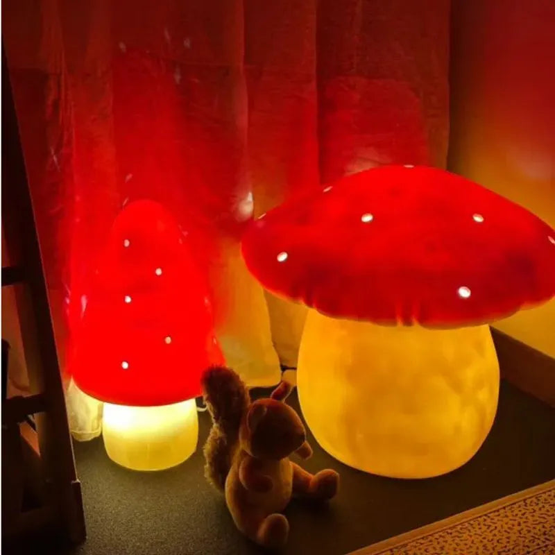 Two Lamp Large Mushroom Red lamps with glowing yellow stems illuminate a cozy children’s bedroom. A plush squirrel sits nearby, framed by red curtains. Each lamp is handcrafted in Germany for a whimsical accent.