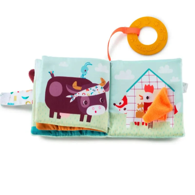 The Lilliputiens I'm Discovering Playbook Farm is a soft, farm-themed playbook featuring crinkly pages and colorful illustrations of a bandana-clad cow with a blue bird and a chicken in a hen house. A textured orange teether adds to this delightful adventure for little ones.
