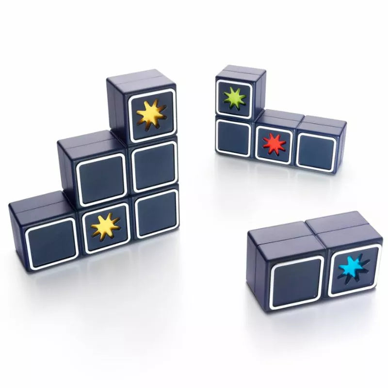 Dark gray blocks, stacked or separate, display colorful starburst patterns on some faces. These resemble the SmartGames Shooting Stars puzzle game and are arranged on a white surface in various formations.
