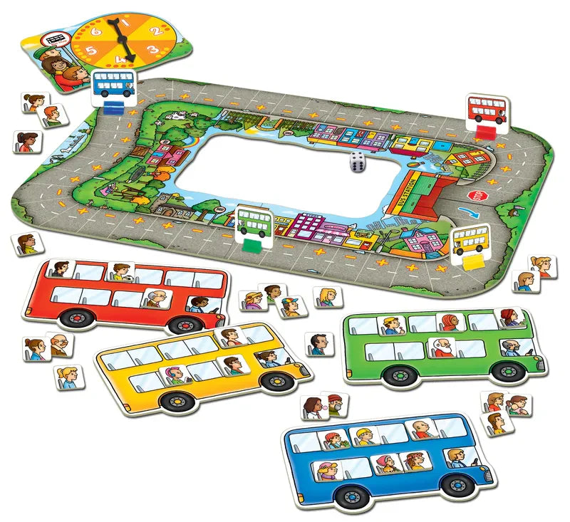 The Orchard Toys Bus Stop game features a vibrant road-shaped track with cartoon buildings, a spinner, and four colorful buses in red, blue, yellow, and green. Each bus comes with cartoon character pieces that can be placed inside.