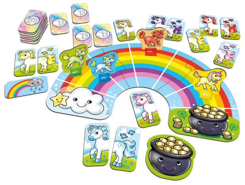 The Orchard Toys Rainbow Unicorns board game showcases a vibrant setup with a rainbow path adorned by various unicorn illustrations. The cards display unicorns in numerous hues, clouds, a cheerful pot of gold, and stars. Both the game pieces and cards are organized neatly in a playful, lively design.