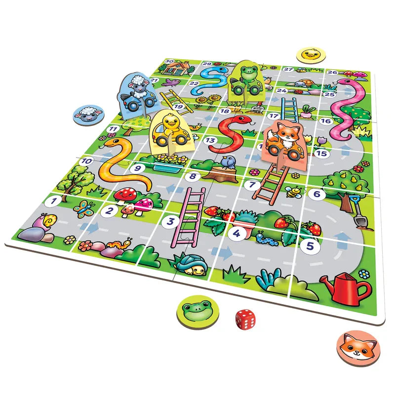 Explore Orchard Toys My First Snakes & Ladders, a vibrant board game set on a numbered path adorned with animals, ladders, and slides. This engaging game comes complete with a die and animal-shaped game pieces including a frog and a fox. The scenic background features trees, flowers, and a winding road.