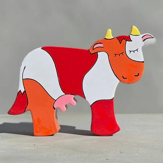 A Magnetic Wooden Cow Play Figure with red and white stripes, perfect for playtime.