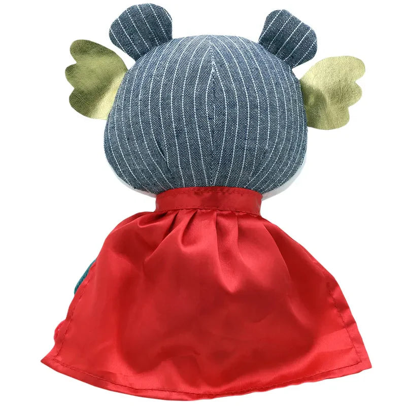 A plush toy viewed from the back, featuring a denim-textured head with bear-like ears, yellow felt wings on either side, and a shiny red cape tied around its neck. Perfect for imaginative play, this Wilberry Super Hero Bear makes an ideal birthday present.