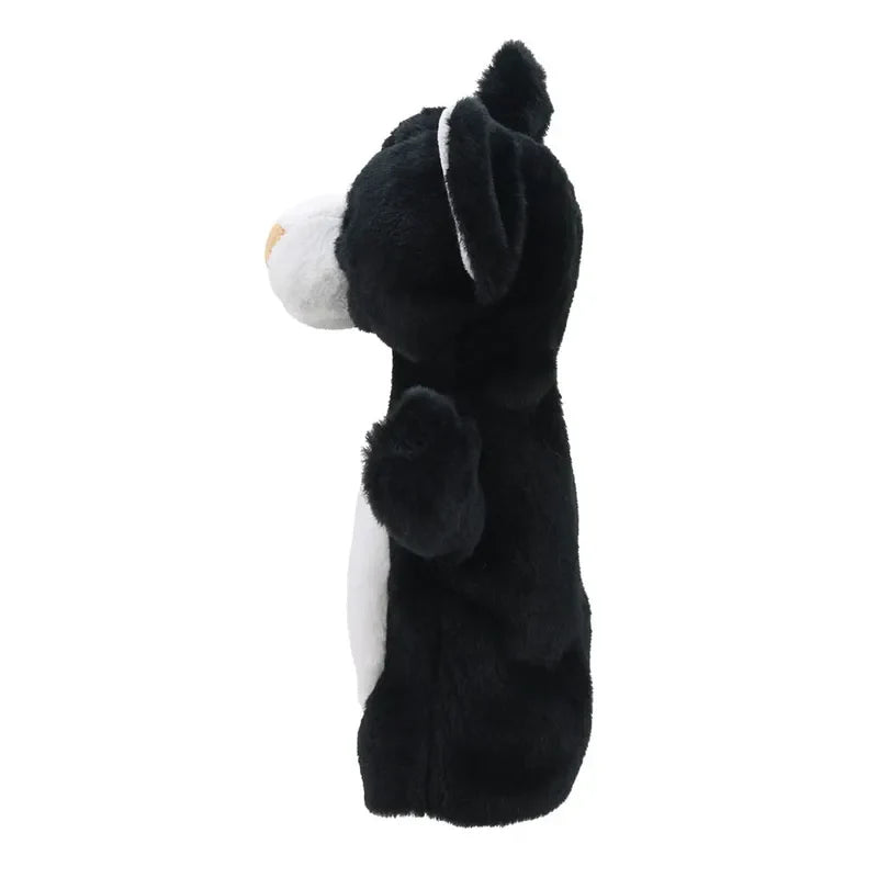 A plush toy depicting a standing ECO Puppet Buddies Black & White Cat Hand Puppet, viewed from the side. The cat has a white muzzle and chest, with upright ears and a thoughtful expression. This toy is part of the Black