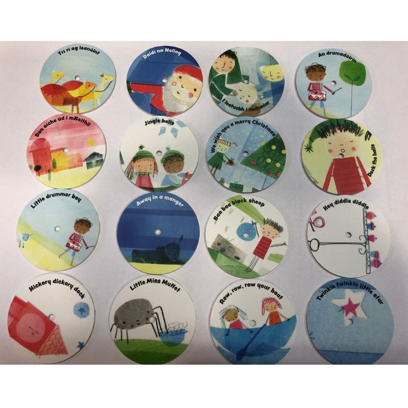 The Mini Gramophone Box Set Christmas Edition includes 16 extra FREE Christmas discs, each round with colorful festive illustrations, featuring children, animals, and joyful scenes, all arranged in a 4x4 grid on a white background.