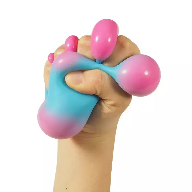 An image depicting a hand squeezing a Colour Changing NeeDoh, with parts of the ball protruding between the fingers.