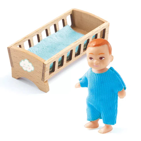 A Djeco Dolls Baby Sasha is standing next to a wooden crib, ready for a puppet show for kids.
