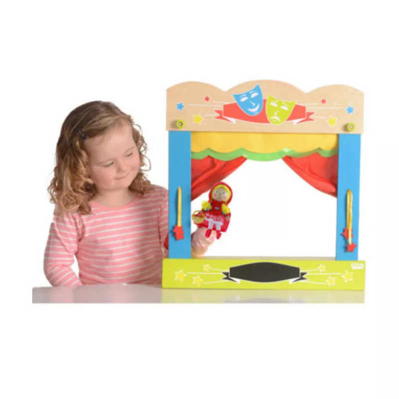 A little girl performing a puppet show with a Fiesta Crafts Carry Case Finger Puppet Theatre.