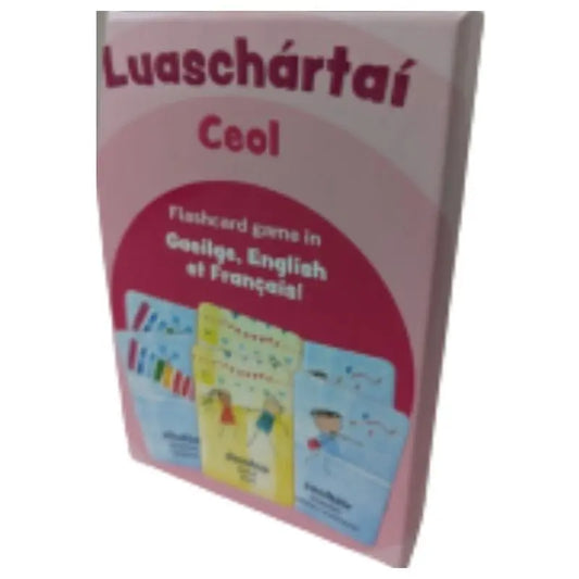 A box of "Luaschártaí - Ceol," a trilingual flashcard game for learning musical terms and instruments in Irish, English, and French, with colorful illustrated cards on the cover.
