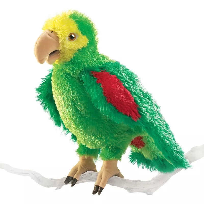 A green and red Folkmanis Puppets Amazon Parrot sitting on a branch.