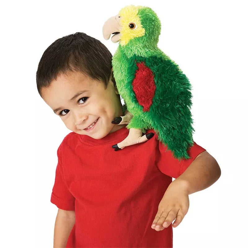 A young boy holding a Folkmanis Puppets Amazon Parrot on his shoulder.