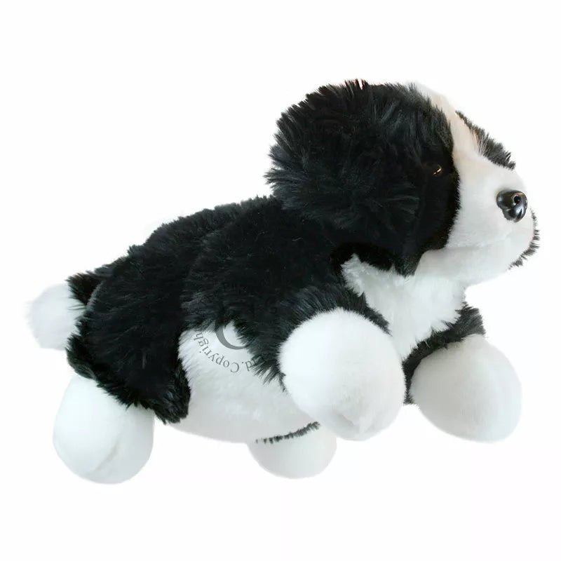 The Puppet Company Full-bodied Hand Puppet Border Collie, a black and white stuffed dog, flying in the air.