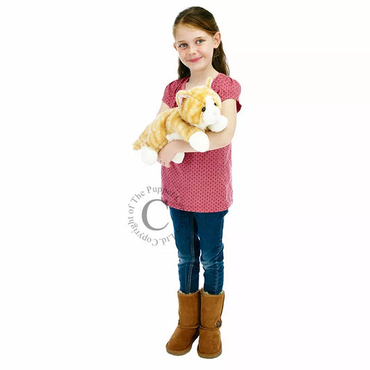 A little girl holding The Puppet Company Full-bodied Hand Puppet Cat Ginger stuffed animal.