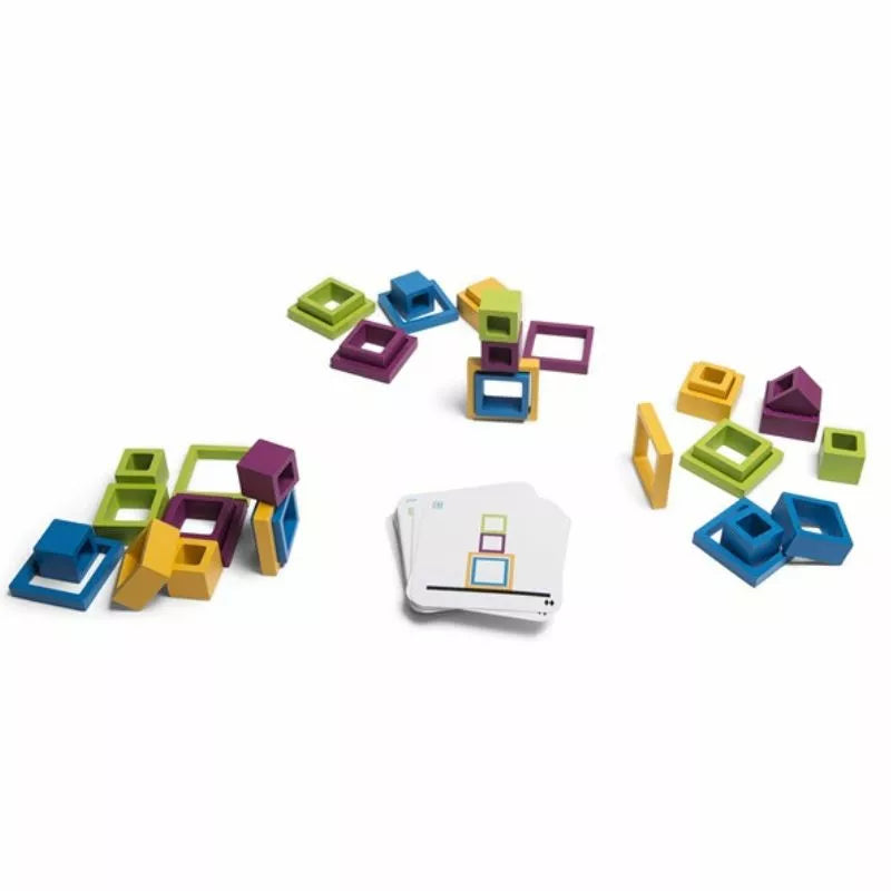 The Buitenspeel Frames Game features an array of colorful geometric shapes, such as cubes and squares in vibrant shades of green, blue, purple, and yellow, artfully arranged around two stacks of cards adorned with geometric designs on a white surface. It's akin to a skill-based game where creating patterns challenges your quick thinking abilities.