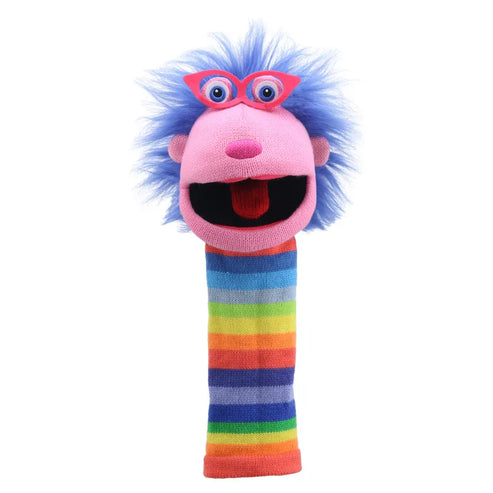 The Puppet Company Sockette Gloria is a vibrant hand puppet boasting a pink face, wide-open mouth, blue hair, and large googly eyes adorned with red glasses. The sock body displays horizontal rainbow stripes in shades of red, orange, yellow, green, and blue. This charming puppet can also double as a squeaker toy for extra entertainment.