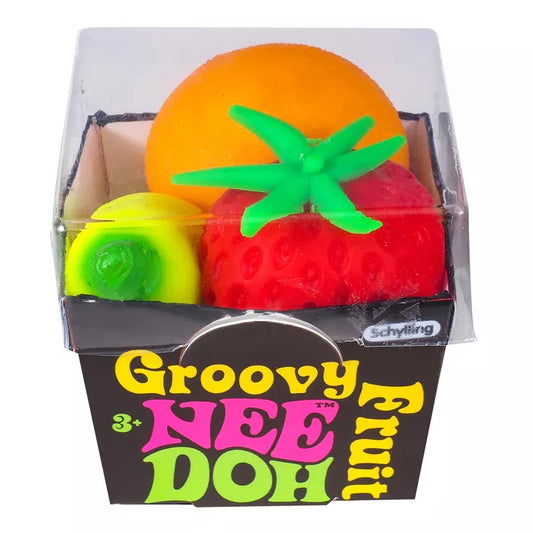 A box labeled "Groovy Fruits Needoh" containing three stress balls shaped like fruit: an orange, a strawberry, and a lime, isolated on a white background.