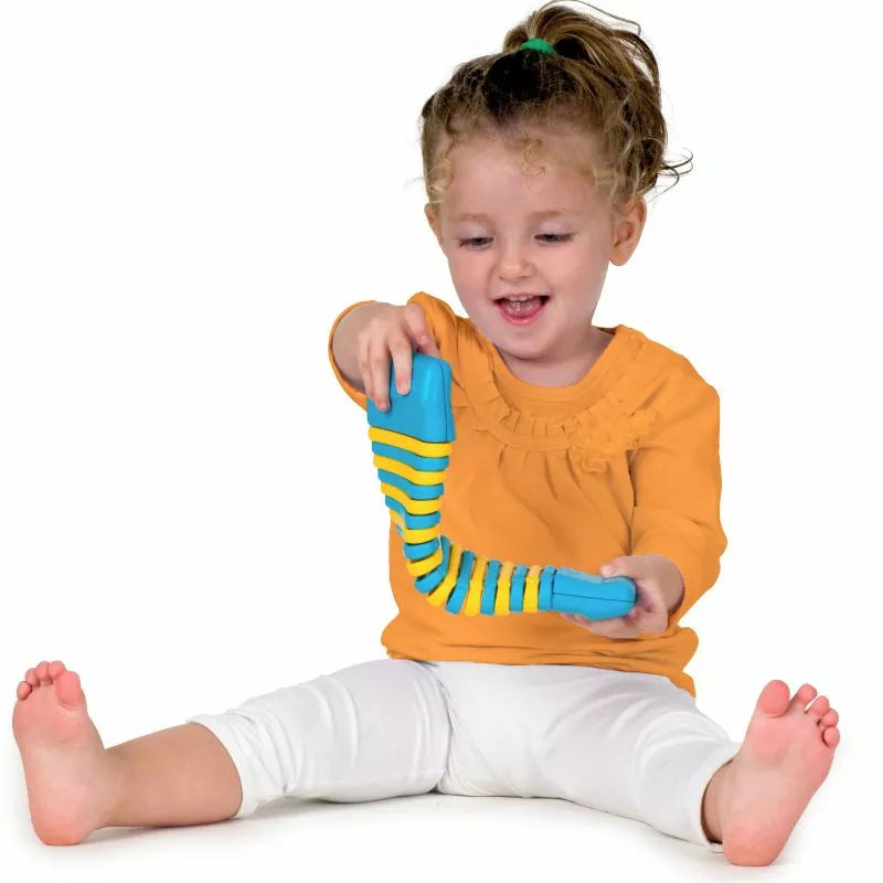 A young girl playing with a Halilit Clatterpillar toy.