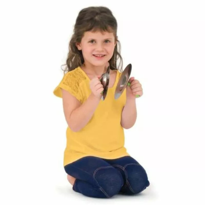 A little girl sitting on the floor holding a pair of Halilit Playsound Cymbals.