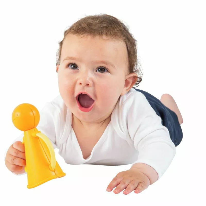 A baby is playing with a yellow Halilit Music Pals Duet.