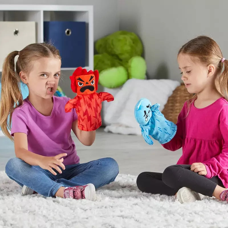 Two little girls sitting on the floor playing with Learning Resources Feelings Family™ Hand Puppets.