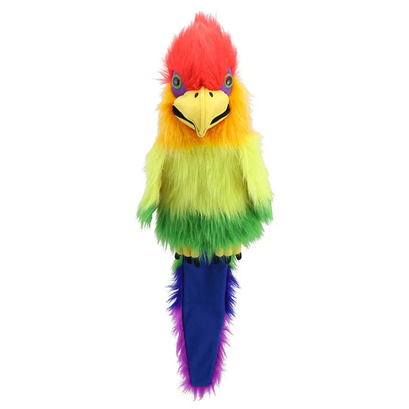 The Puppet Company Rainbow Bird Hand Puppet is a stunning, colorful hand puppet resembling a parrot. It features vibrant feathers in a rainbow gradient of red, orange, yellow, green, and blue. The puppet boasts large blue eyes and a yellow beak, with a tail that is mainly purple-blue in color. Fluffy and soft to the touch, it also includes a squeaker in the mouth for added fun.