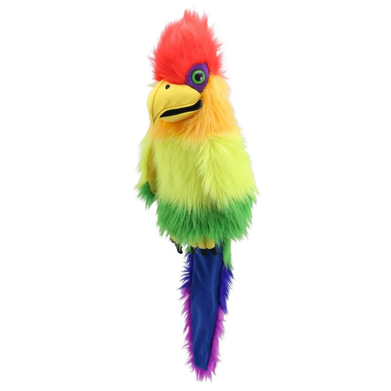 The Puppet Company Rainbow Bird Hand Puppet is a stunning toy featuring fluffy, vibrant feathers in red, orange, yellow, green, blue, and purple. It has a large yellow beak and big green eyes surrounded by blue feathers. The puppet also boasts a long blue and purple tail and includes a squeaker in its mouth for added charm against a white background.