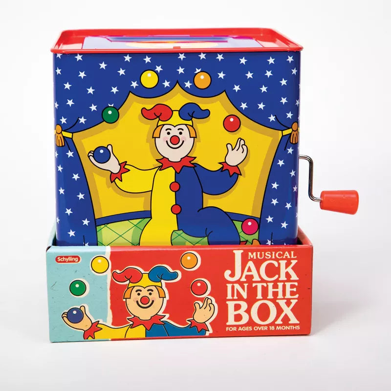 A colorful "Jester Jack In Box" toy with a clown popping out of a blue box adorned with circus graphics. The box has a red crank and is labeled as a toy for toddlers over 18.