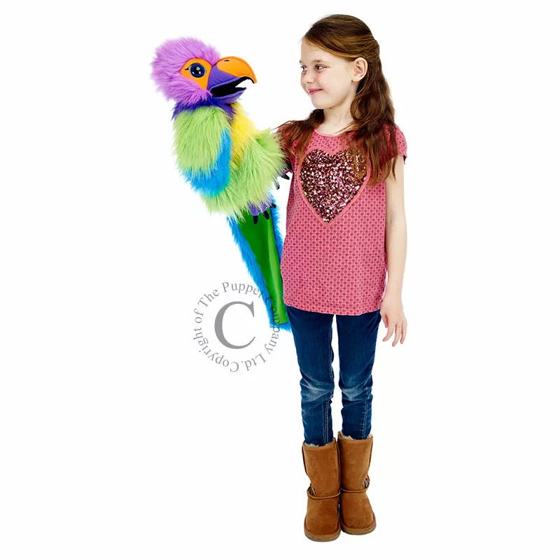 A girl performing a puppet show with The Puppet Company Large Plum-Headed Parakeet stuffed animal.