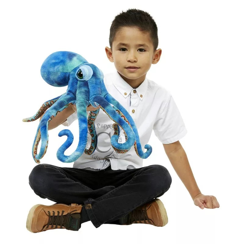 A young boy showcasing a puppet show with The Puppet Company Large Creatures Octopus stuffed animal.