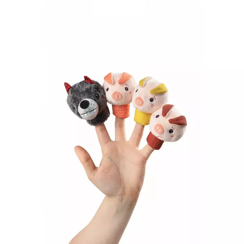 A hand displaying the Lilliputiens Louis The Wolf And The 3 Little Pigs Finger Puppets, perfect for the little ones.