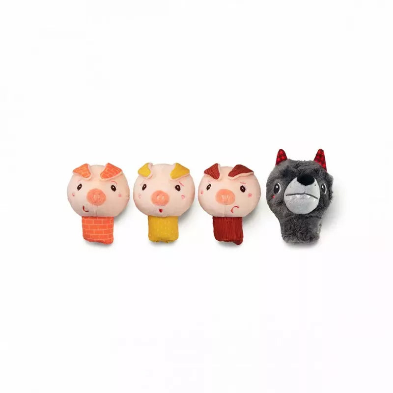 A lineup of four Lilliputiens Louis The Wolf And The 3 Little Pigs Finger Puppets: three cute pigs with different colored outfits and expressions next to a plush wolf with a mischievous grin, perfect for the little ones.