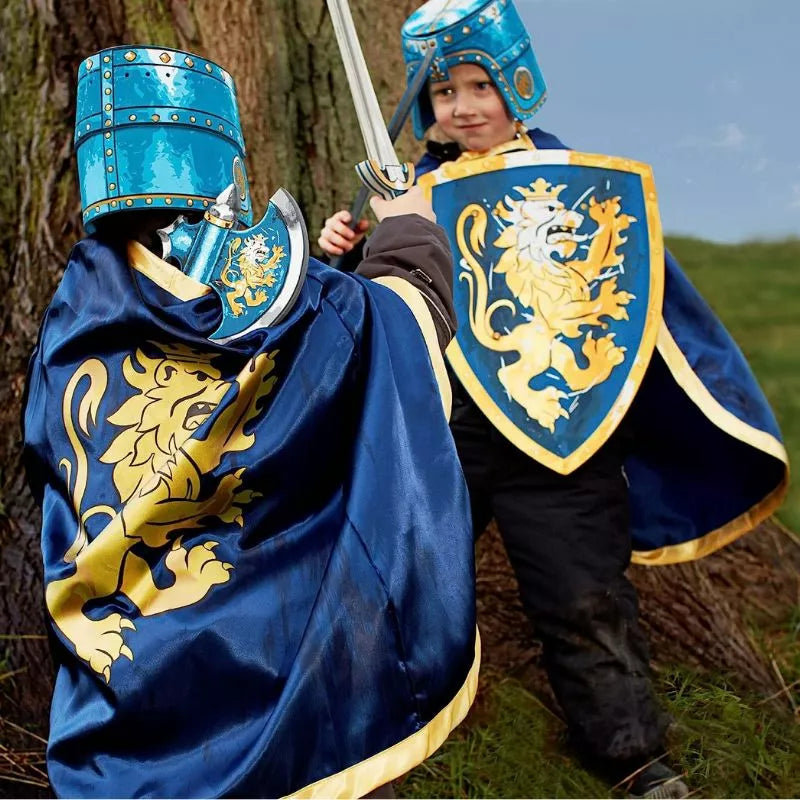 Two kids dressed as knights in a puppet show, wearing Liontouch Noble Knight Capes.
