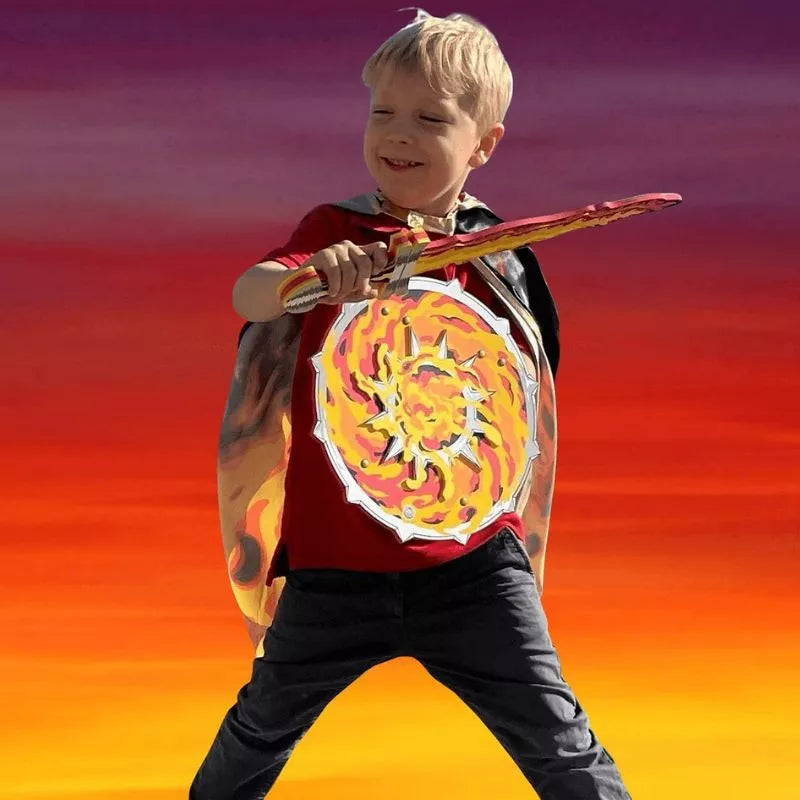 A young boy wearing a Liontouch Flame Shield and holding a sword participates in a puppet show for kids.