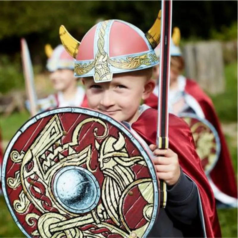 A group of children dressed as vikings holding Liontouch Viking Helmets.