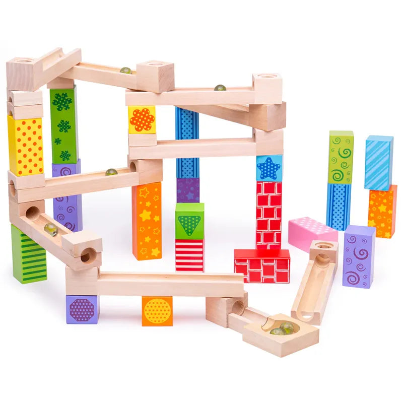 The Bigjigs Marble Run is a vibrant wooden set with diverse blocks and tracks that spark creative play. It showcases colorful patterns including stars, dots, and stripes in red, blue, green, yellow, and purple. Marbles race along the intricately designed tracks of this educational toy.