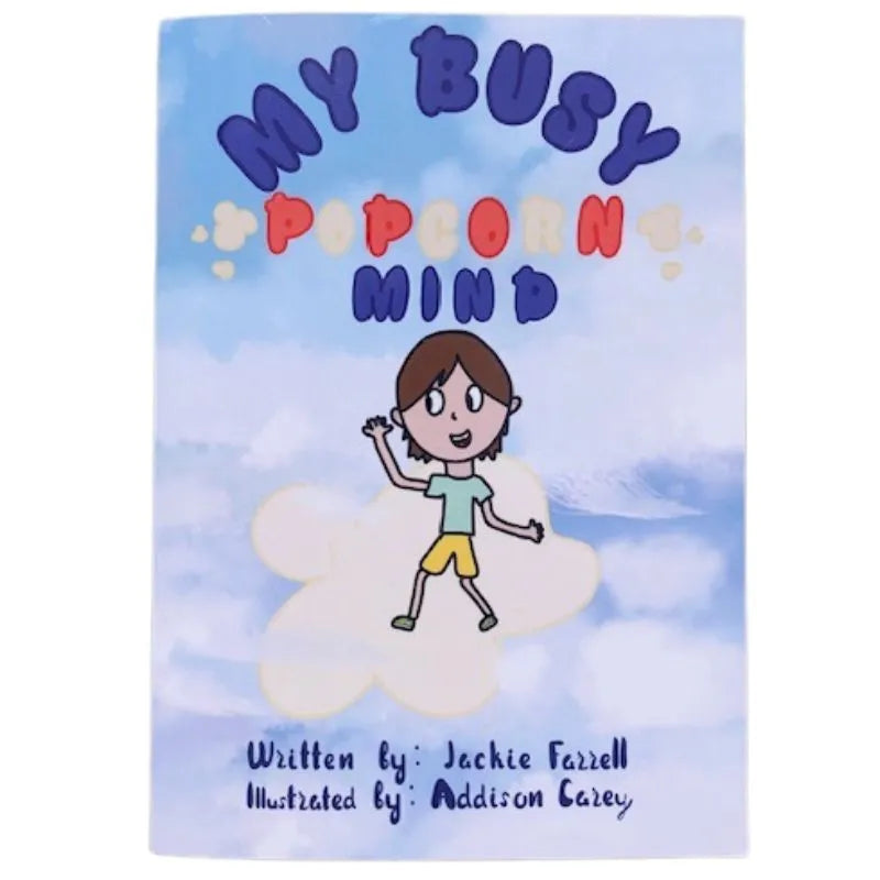 The children's book titled "My Busy Popcorn Mind" features an illustration of a happy child in casual clothes waving while sitting on a fluffy white cloud. The blue background with light clouds complements the theme of mindfulness. Written by Jackie Farrell and illustrated by Addison Carey, this children's book inspires self-compassion.