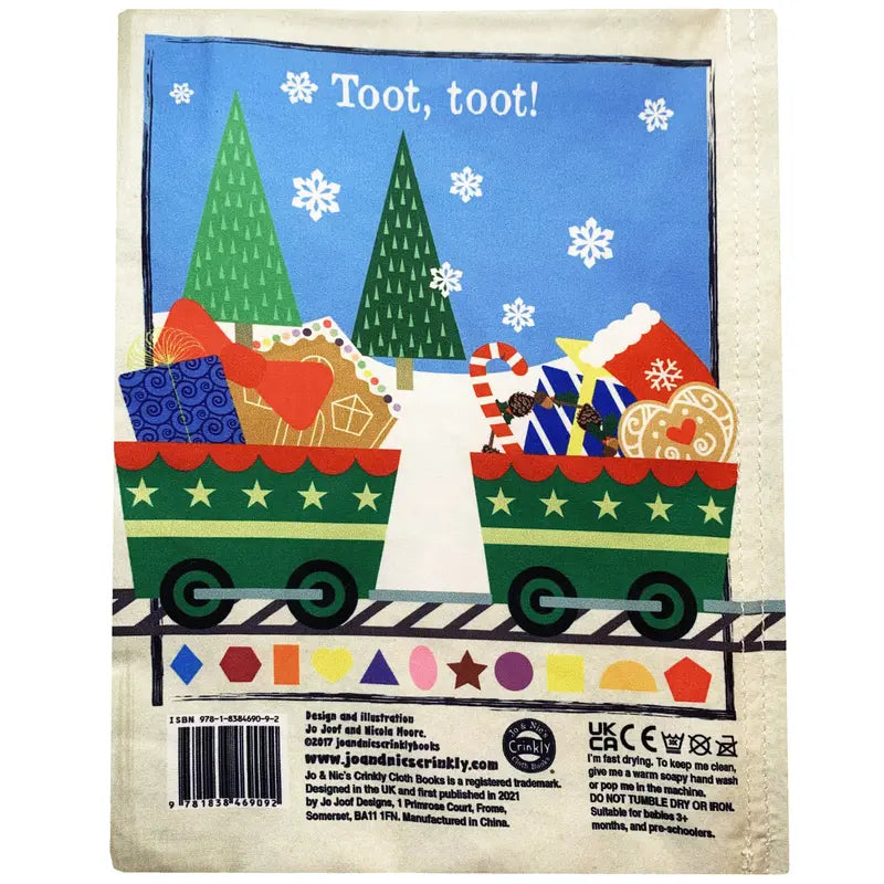 The Crinkly Cloth Book Christmas Shapes features a festive Santa’s Express train with two green cars full of gifts and candy, snowy pine trees in the background, and "Toot, toot!" for a charming holiday baby book scene.