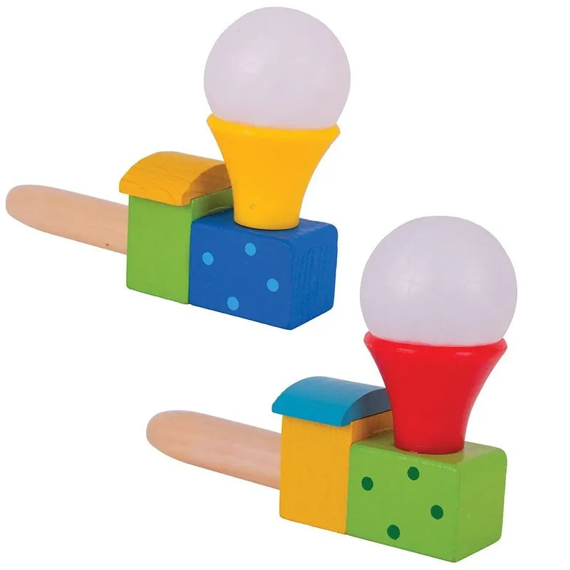 Introducing the Bigjigs Puffing Train: Featuring two vibrant wooden toys that make perfect stocking fillers, each set includes a ball balanced atop blocks. One toy showcases a yellow funnel and blue block, while the other displays a red funnel and green. Equipped with wooden handles, these toys resemble simple musical instruments or noise-makers and are ideal for promoting mouth muscle development in children.