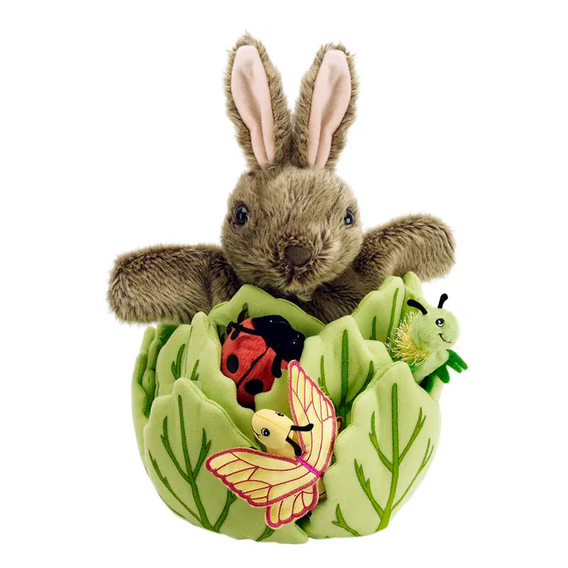 The Puppet Company Hide-Away Rabbit features a plush bunny nestled in a soft green cabbage with fabric leaves, accompanied by finger puppet insects—a ladybug, caterpillar, and butterfly—for imaginative play.